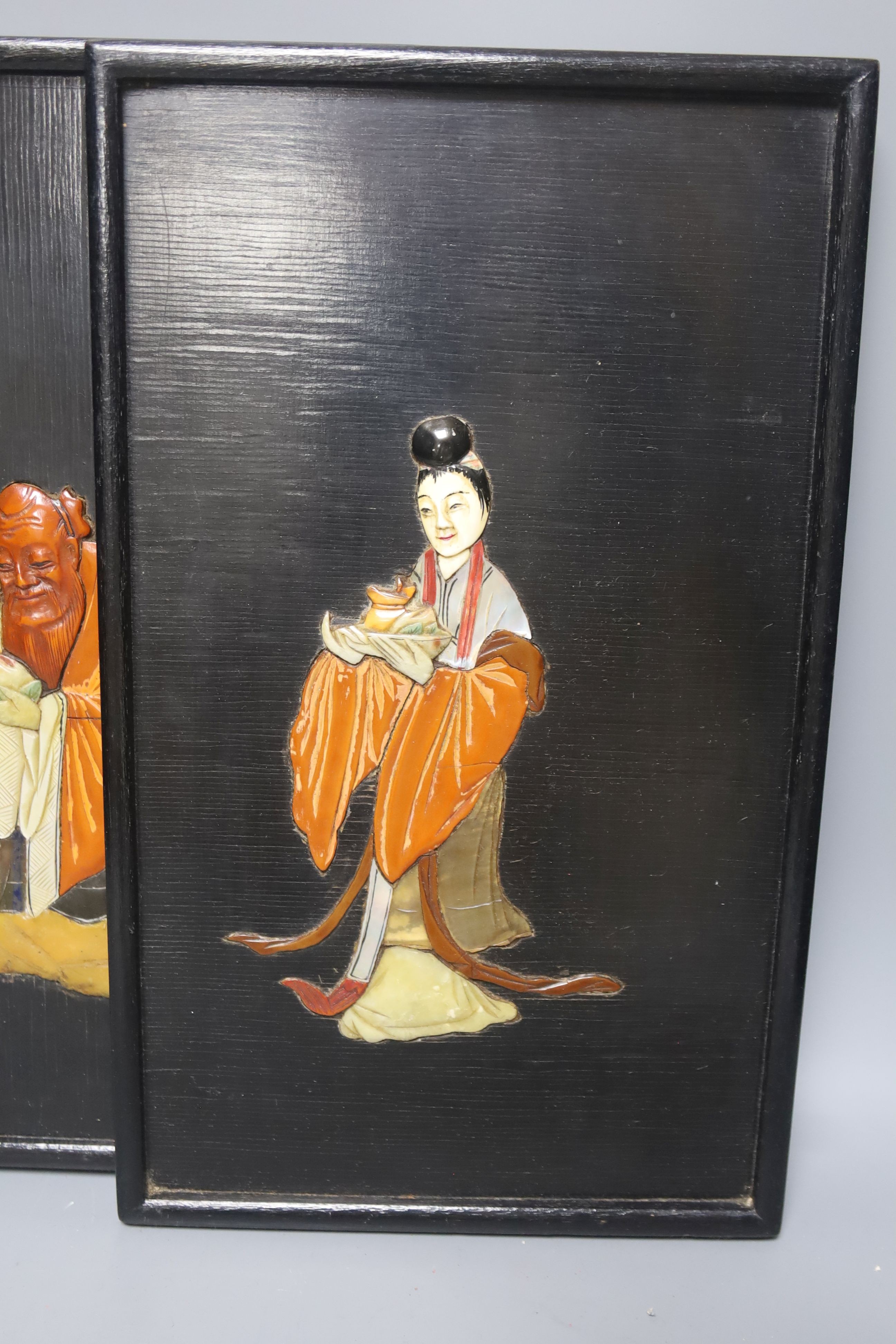 A pair of Chinese soapstone inlaid lacquer panels of two immortals, early 20th century 34x20cm